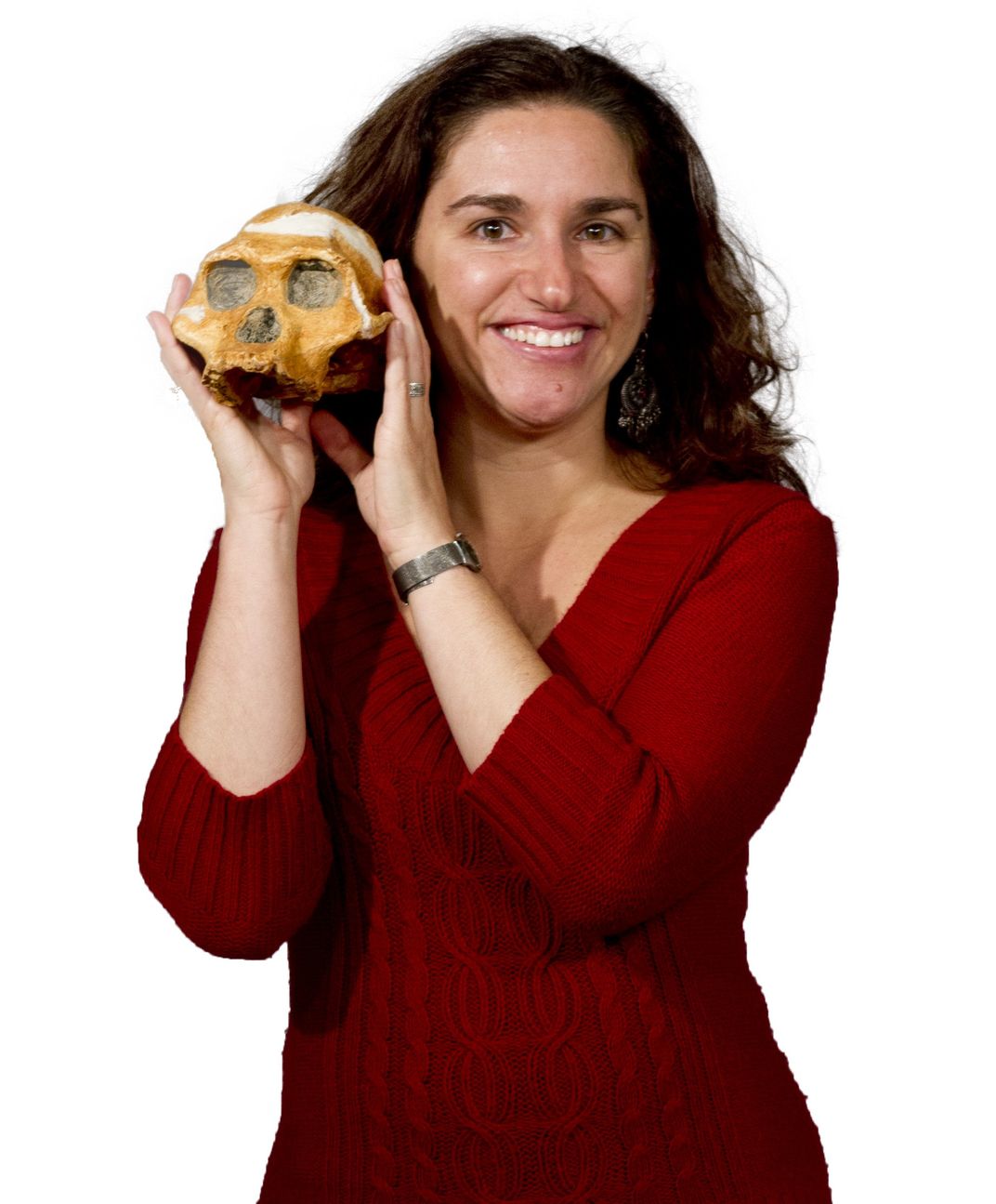 Person holding an early human skull next to their head