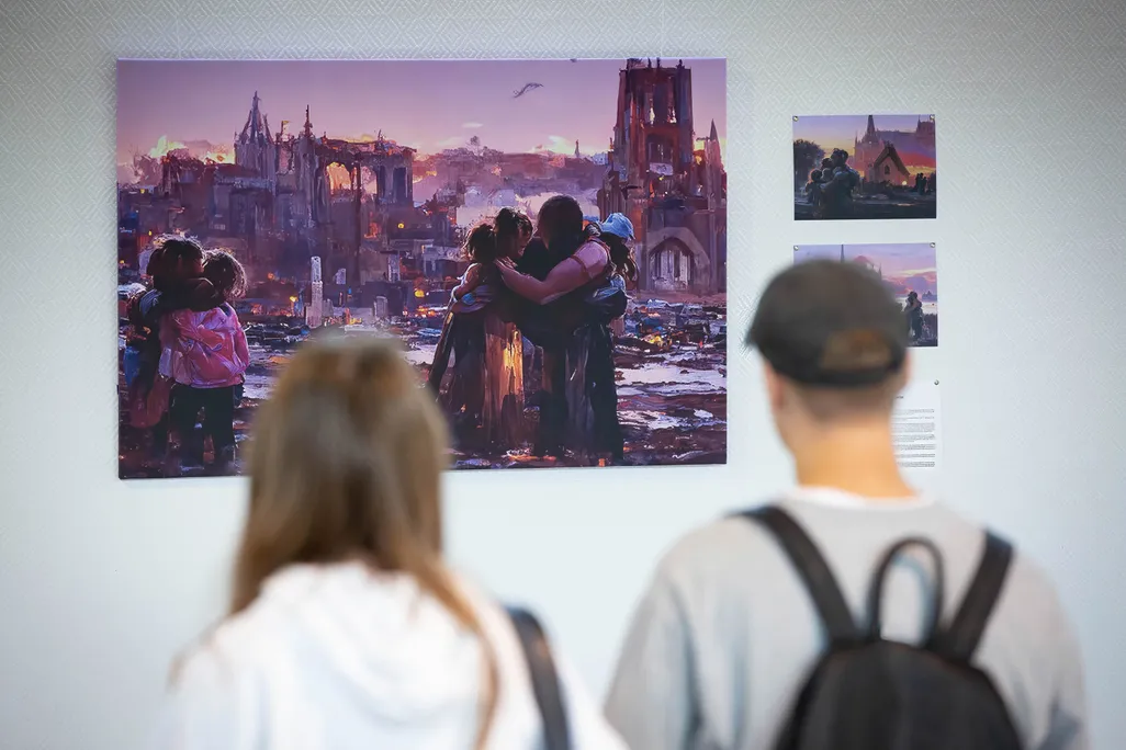 People look at an image generated based on the stories of displaced children during the evacuation from hot spots in the south-east of Ukraine in Kyiv. The exhibition of these pictures is called 'Save Ukr(AI)ne'.