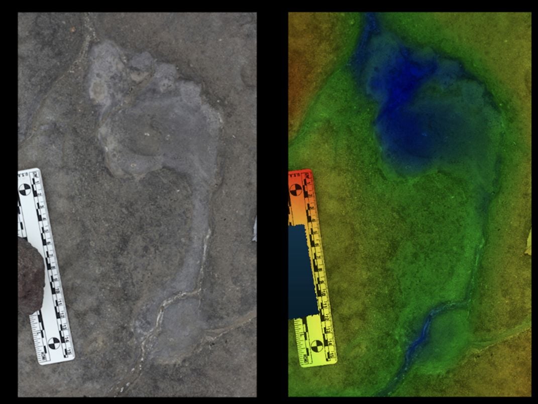 A footprint in dirt next to a green and blue footprint.