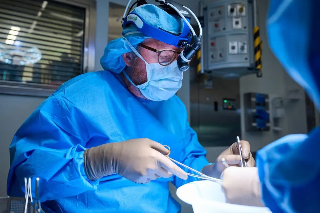 A doctor in scrubs operates