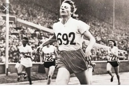Fanny Blanker-Koen crosses the finish line to become the first triple champion of the 14th Olympic Games.