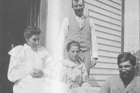 Susan, far left, with her husband (seated with puppy) at their Bancroft, Nebraska, home.