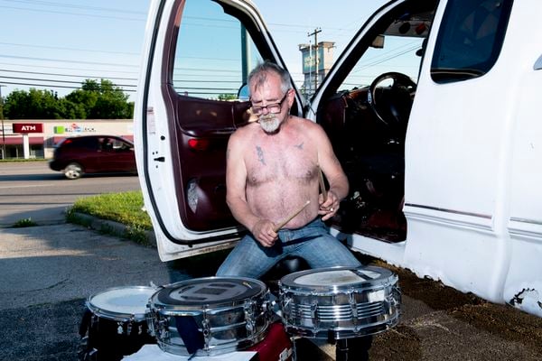 A man playing drums outside Revive 66 campground. thumbnail