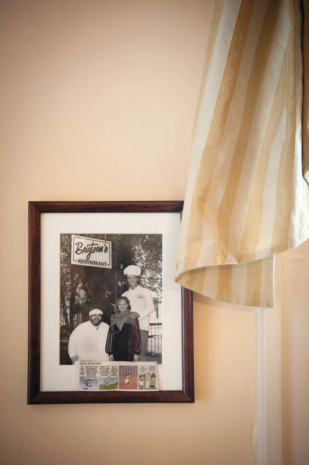 a portrait of two chefs hanging on a wall