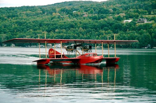 A reproduction of the 1914 Curtiss flying boat America takes to the water.