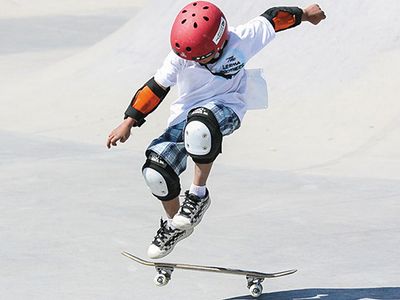A young boy lands a kickflip at an intertribal skate jam in Albuquerque.