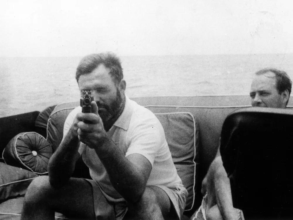 1599px-Ernest_Hemingway_Aboard_the_Pilar_1935.png