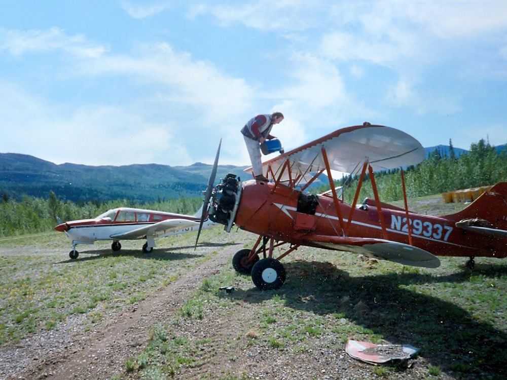 pilot refueling 1940 Waco on gravel strips