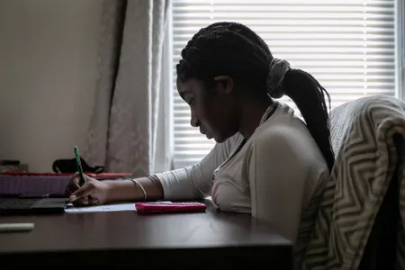 Abigail Previlon, 13, takes part in online learning at home on October 28, 2020 in Stamford, Connecticut. At the time, Stamford Public Schools was using a hybrid educational model due to the Covid-19 pandemic.