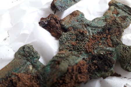 A fragment of 1,500-year-old cloth is still attached to a metal brooch found at the site.