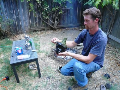 Study co-author Kevin Smith applies melted bitumen to a bottle, following a technique used by indigenous groups of the California Channel Islands. 