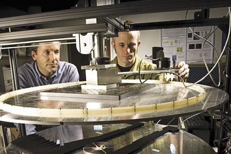 Duke University’s Steven Cummer (left) and David Schurig of North Carolina State University prepare to test a cloaking device by bombarding it with microwaves.