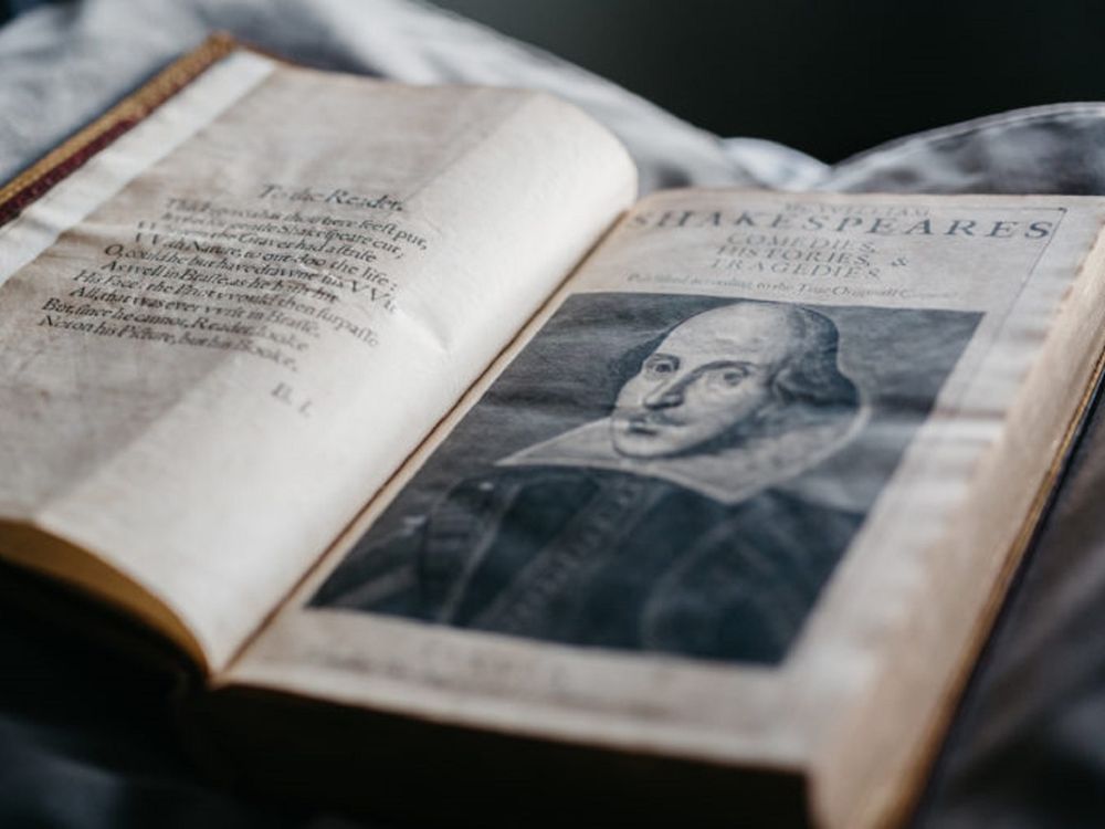 Open book with illustration of Shakespeare on the right-hand page