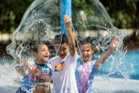 Kids cool down at an animal-themed splash pad at Zoo Miami. Mist stations also help visitors avoid overheating on sweltering days.