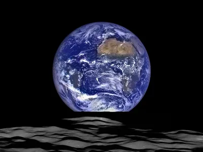 A nearly full Earth rises above the lunar surface, soon to be visited again by American astronauts. 