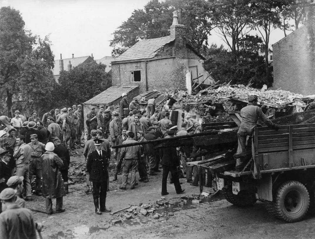 American airmen and villagers at the crash site in August 1944