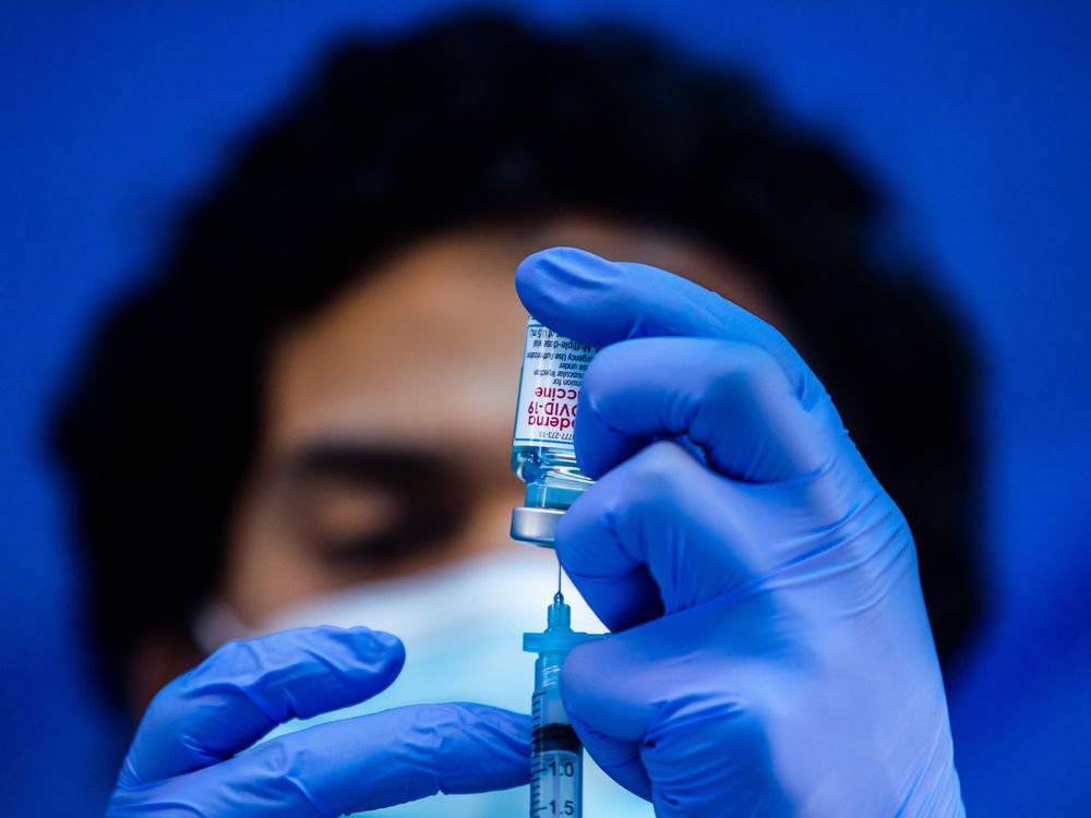 A medical worker loads a syringe with the Moderna Covid-19 vaccine to be administered at a vaccination site in Los Angeles, California