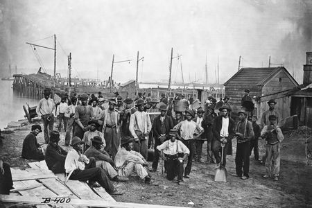 A group of freed African American men along a wharf during the Civil War.