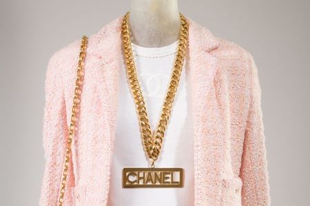 Chanel (Karl Lagerfeld), suit, pink wool and synthetic blends, white cotton, spring 1994, France, gift of Chanel Inc. Chanel (Karl Lagerfeld), necklace, gold plated metal, fall 1991, France, Gift of Depuis 1924.