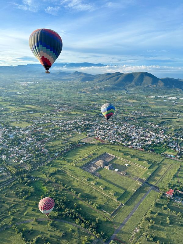 Hot air balloons soar over the ruins of Teotihuacan outside of Mexico City. thumbnail