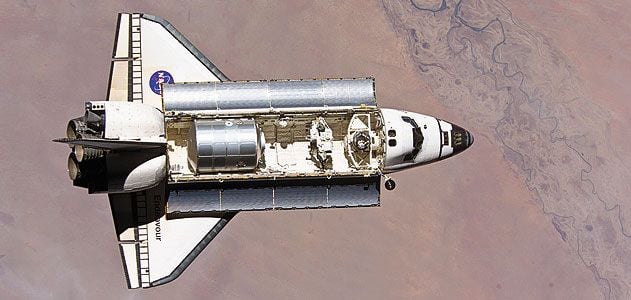 The shuttle main engine is the most tested large rocket engine in the world. In 1996, a turbine component (displayed here by a NASA scientist) underwent airflow tests to help engineers create more eff