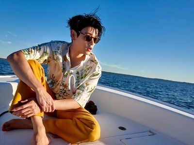 Eric Nam sitting on a boat in the ocean