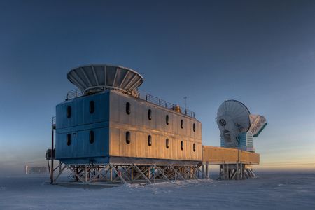 Less than a mile from the South Pole, the Dark Sector Lab’s Bicep2 telescope (at left) searches for signs of inflation. 