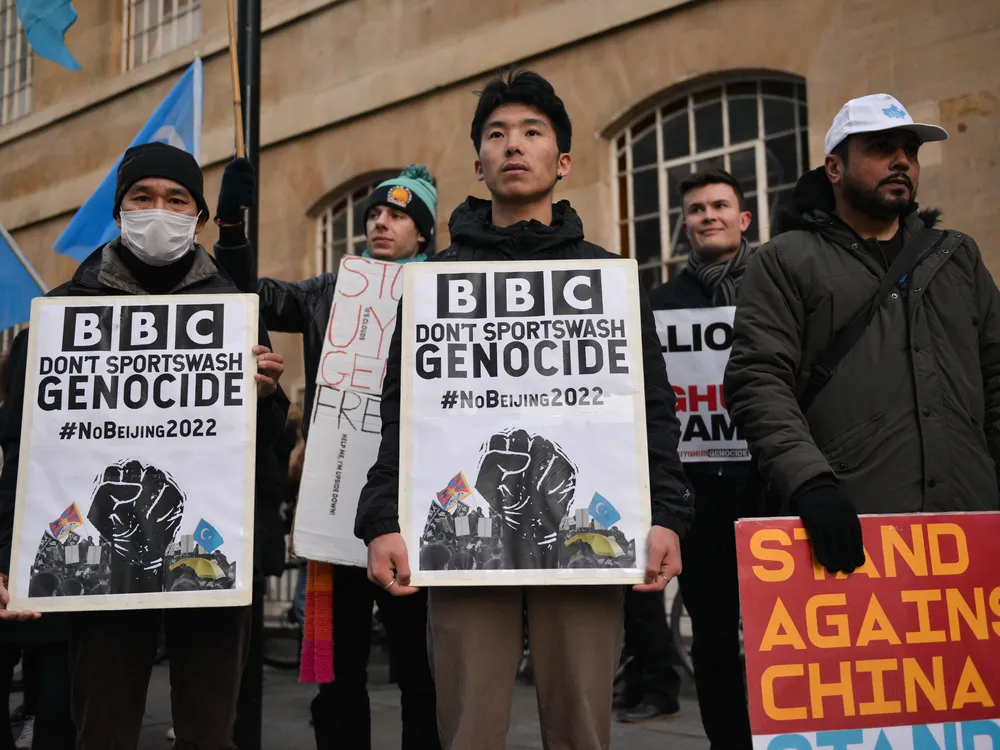 Activists in London hold signs urging the BBC to boycott the 2022 Olympic Games in Beijing