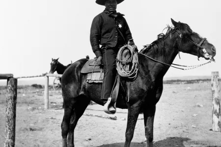 An African-American cowboy sits saddled on his horse in Pocatello, Idaho in 1903. 