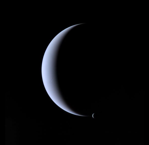 Crescent Neptune and its largest satellite