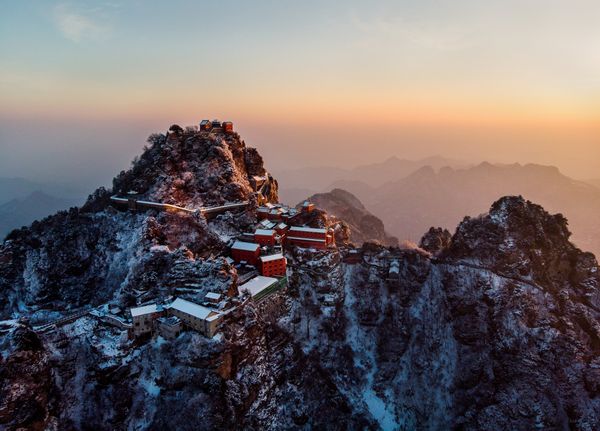 The summit of Wudang Mountain in China is bathed in the golden sunrise.