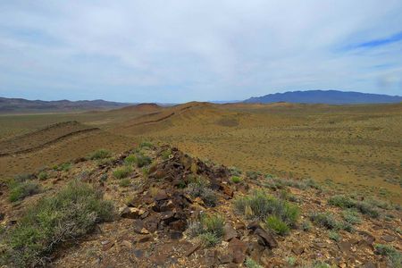 In the mountains of southwestern Nevada, the dark fossilized remnants of extinct archaeocyath reefs dot the tops of the hills. Millions of years ago, these peaks were at the bottom of the sea.