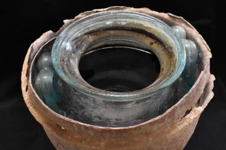 The wine, made of crushed white grapes 2,000 years ago, turned red-brown with age.