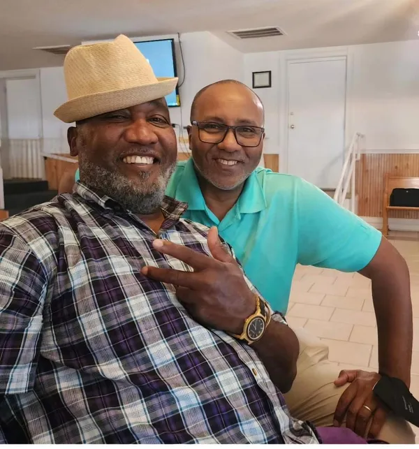 Brother-in-Laws sharing a laugh at their mother/mother-in-law's 90th birthday part thumbnail