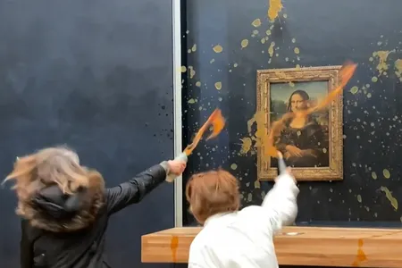 Protesters throw soup at the Mona Lisa&#39;s protective glass covering at the Louvre on January 28.