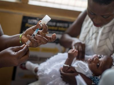 A baby receives a mallaria vaccine from a nurse at the maternity ward of the Ewin Polyclinic in Ghana in 2019.