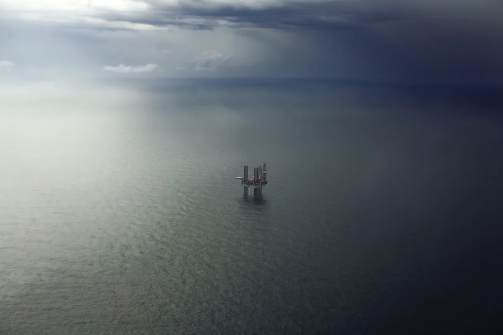An oil platform sits in the ocean