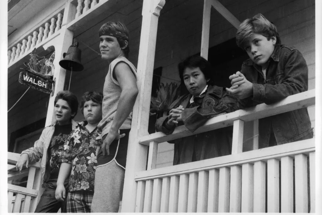 Corey Feldman, Jeff Cohen, Josh Brolin, Ke Huy Quand and Sean Astin standing on porch in a scene from the film 'Goonies'