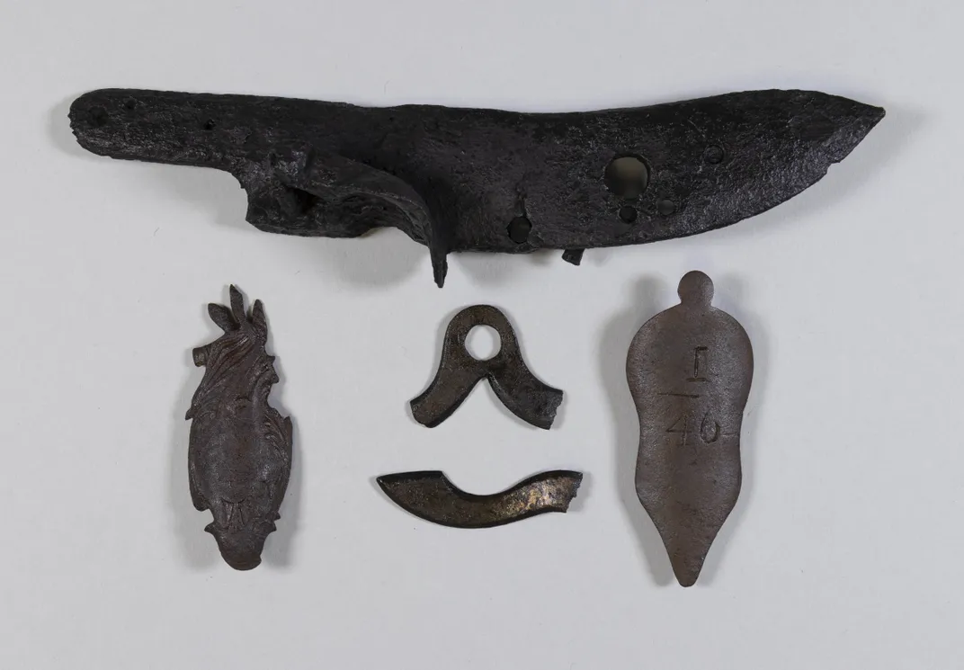 Dark pieces of metal against white backdrop