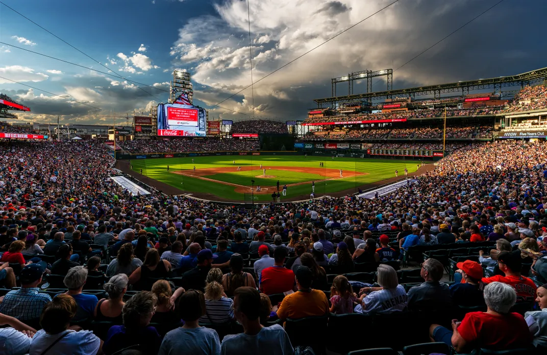 a crowd fills a baseball stadium