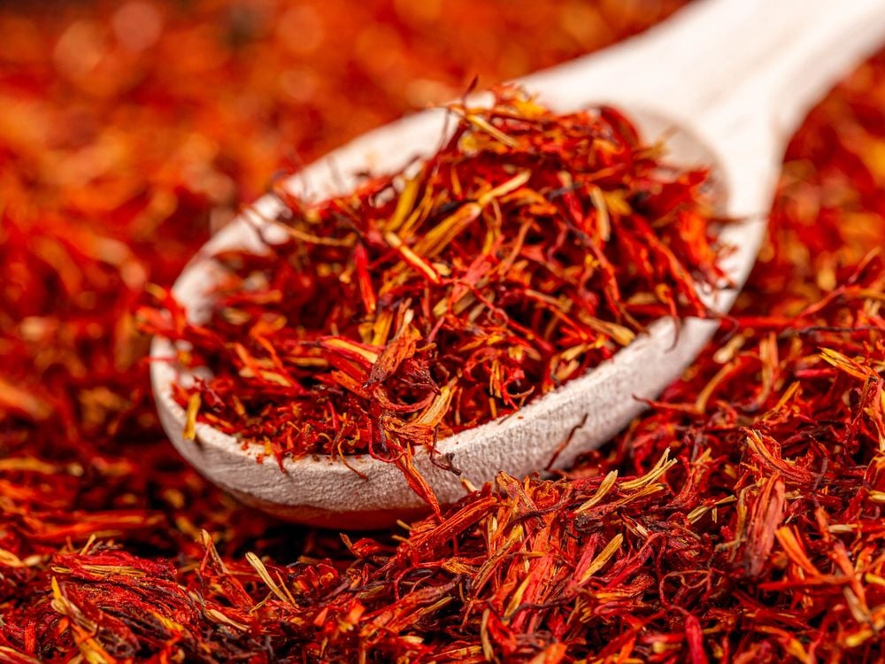 Pile of saffron with wooden spoon