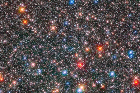The smaller white stars in this Hubble Space Telescope image of the central region of our galaxy are of the same type as the Sun. But our local star may be unusual in its ability to foster life.