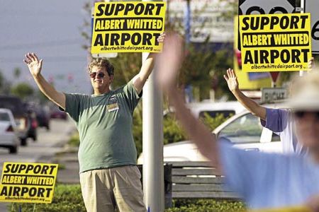 In 2003, Steve Lange (left) chaired a sign-waving group that met each Friday at a different intersection in the city.