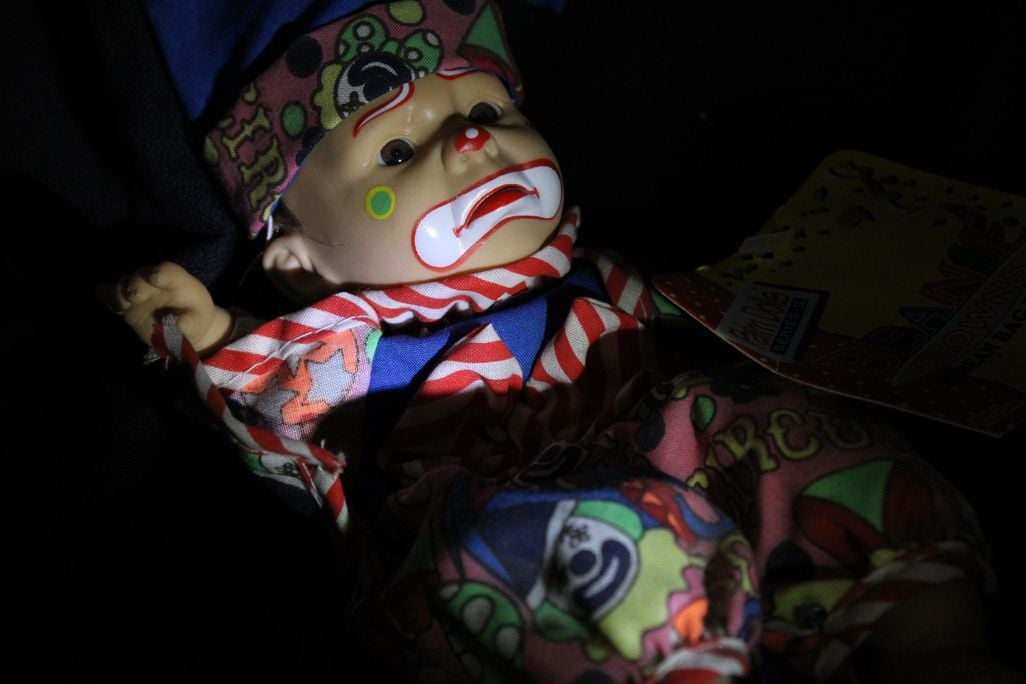 Spooky doll with clown makeup on