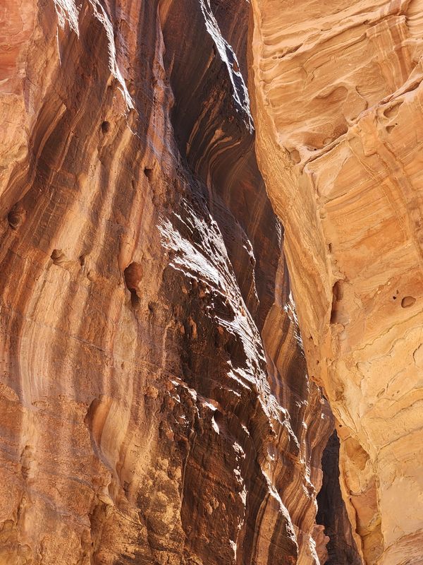 Sun filtering through rock formations in Petra, Jordan thumbnail