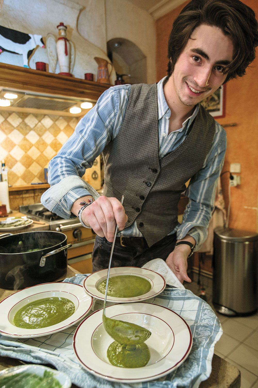 Alexis Marot spoons out watercress soup for the meal's first course. (Owen Franken)