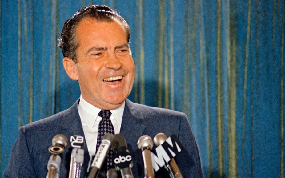 Republican presidential candidate Richard Nixon smiles for the cameras during a 1968 news conference.