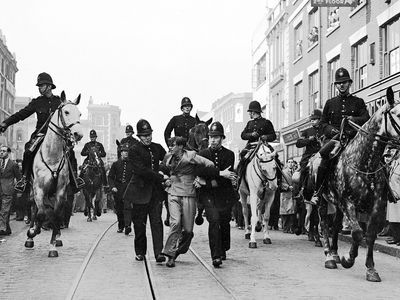 In this 1936 photo by Eddie Worth, an anti-fascist demonstrator is arrested during the Battle of Cable Street in London.