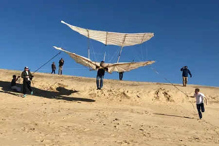 Kitty Hawk Kites founder John Harris flying the Lilienthal glider in December 2019.