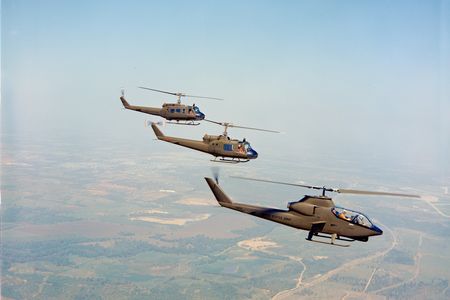 Bell Helicopter’s prototype for the AH-1G Cobra flies in front of two UH-1 Hueys, the aircraft it was designed to protect.